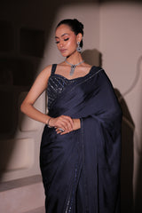 Model wearing a navy blue embellished saree with a detailed blouse, styled for wedding receptions and elegant evening occasions.