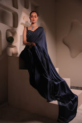 Model wearing a navy blue embellished saree with a detailed blouse, styled for wedding receptions and elegant evening occasions.